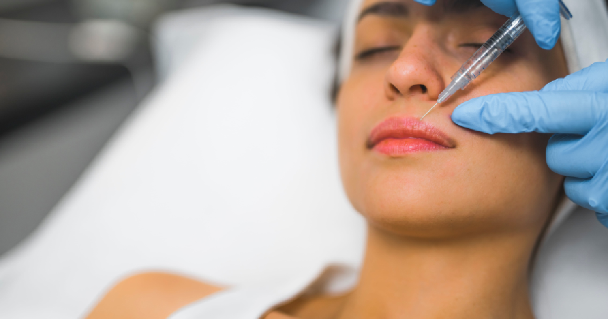 woman receiving a dermal filler injection in the nasolabial fold area by a medical professional in Ellicott City, Maryland